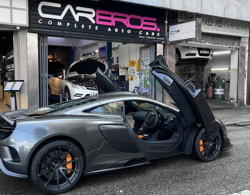 McLaren with dihedral doors open at CarBros workshop
